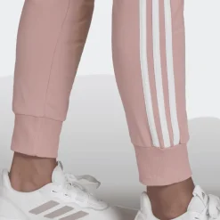 PANTALONI SPRTIVI DA DONNA ADIDAS ESSENTIALS ROSA CON STRISCE BIANCHE